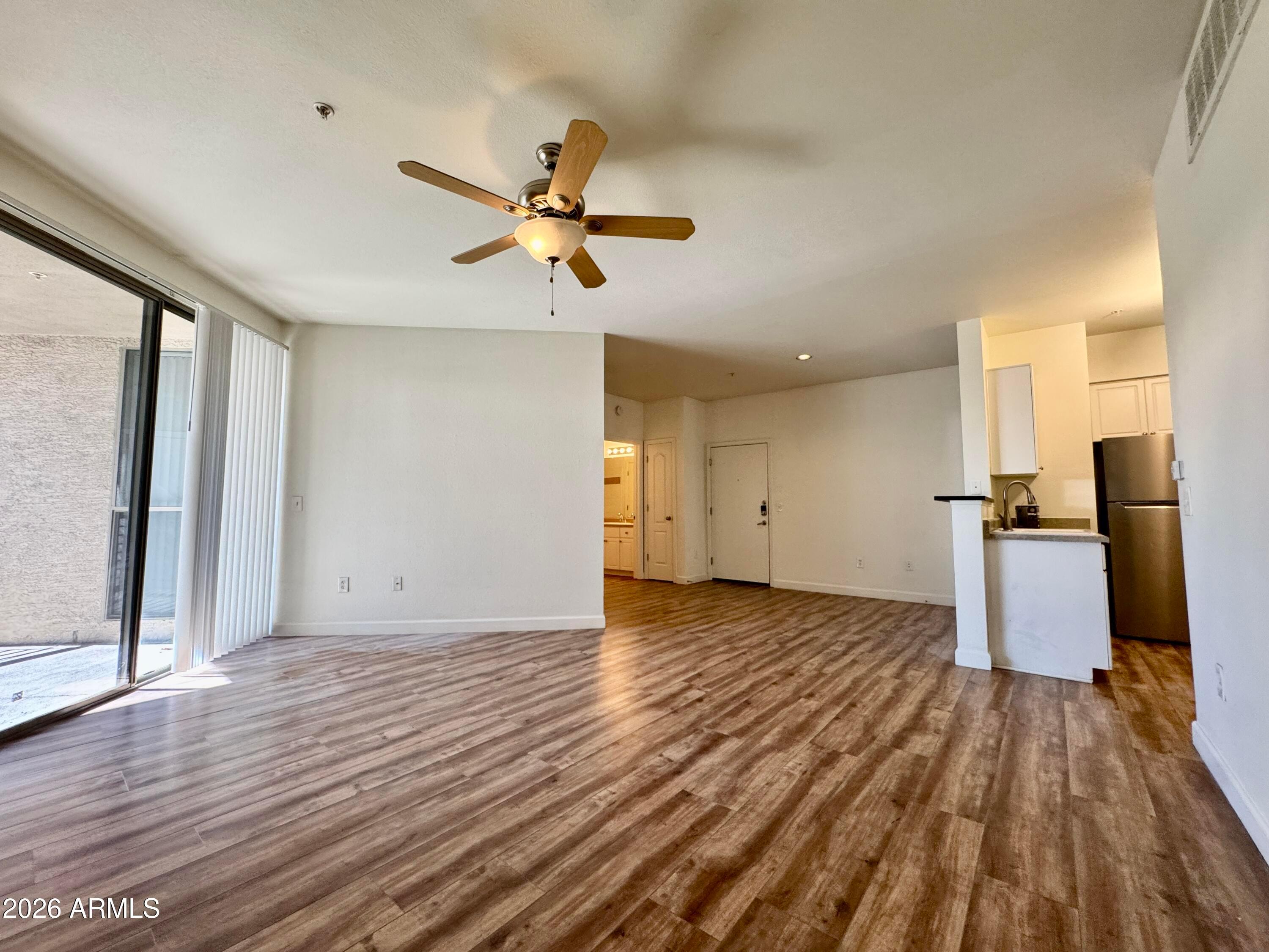 1701 East Colter Street, Unit 465 Phoenix, AZ 85016 - Photo 14 of 25 a view of empty room with wooden floor and fan