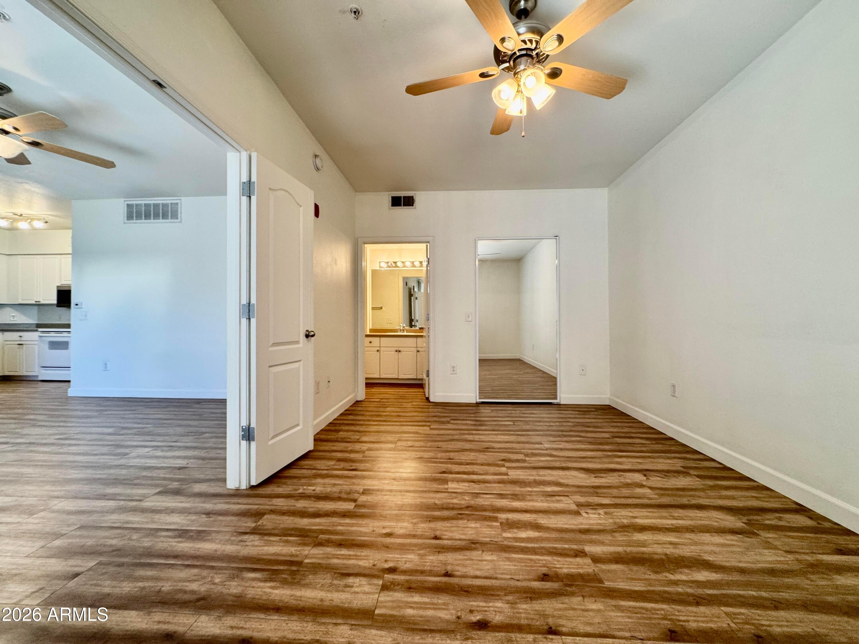 1701 East Colter Street, Unit 465 Phoenix, AZ 85016 - Photo 20 of 25 a view of an empty room with window and wooden floor