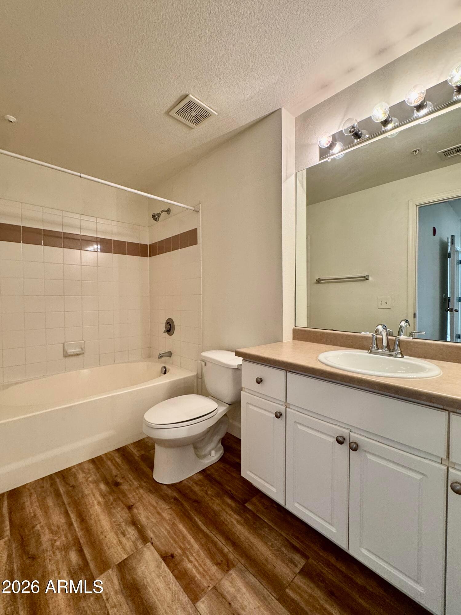 1701 East Colter Street, Unit 465 Phoenix, AZ 85016 - Photo 22 of 25 a bathroom with a toilet a sink a mirror a bathtub and vanity