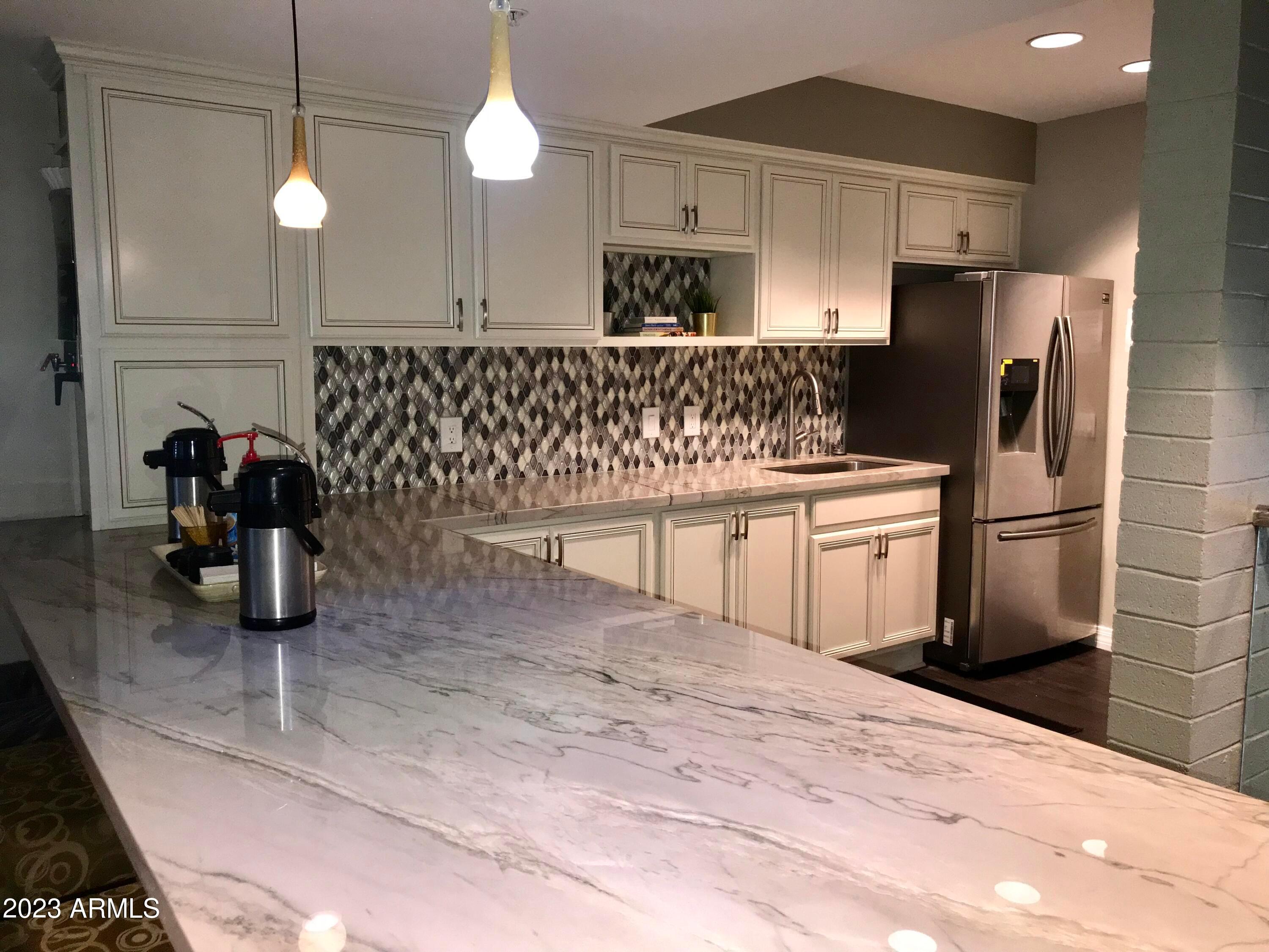 1701 East Colter Street, Unit 465 Phoenix, AZ 85016 - Photo 8 of 25 a kitchen with a sink cabinets and stainless steel appliances