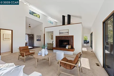 a view of a dining room with furniture a chandelier and wooden floor