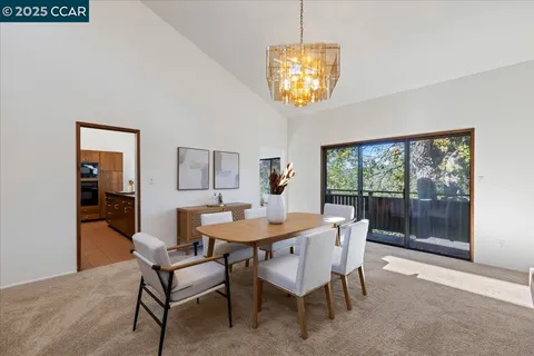 a living room with furniture a large window and a sink