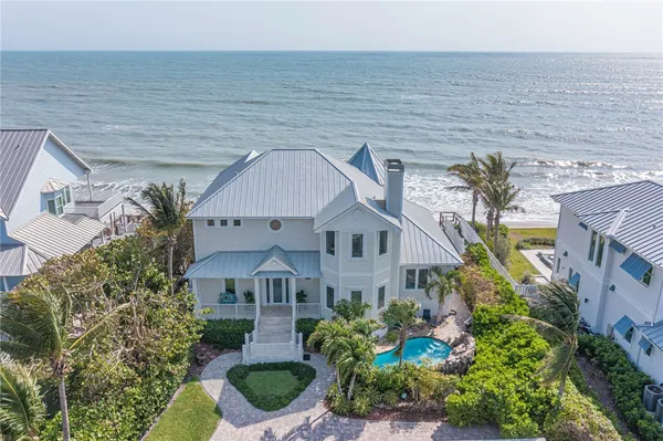 a aerial view of a house with a yard and potted plants