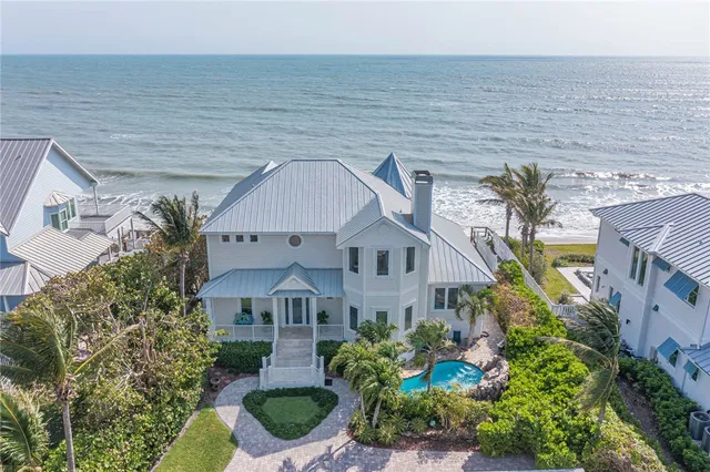 a aerial view of a house with a yard and potted plants