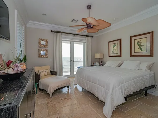 a spacious bedroom with a bed and a chandelier