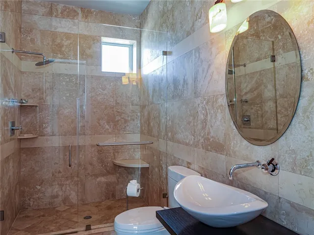 a bathroom with a toilet sink and mirror