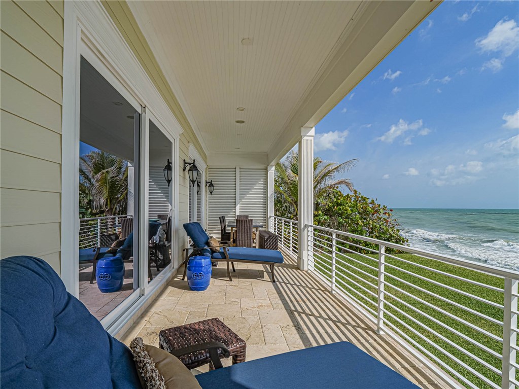 2250 Sanderling Lane Vero Beach, FL 32963 - Photo 24 of 36 a balcony with chairs and wooden floor