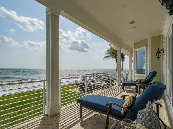 a view of a balcony with chair and table