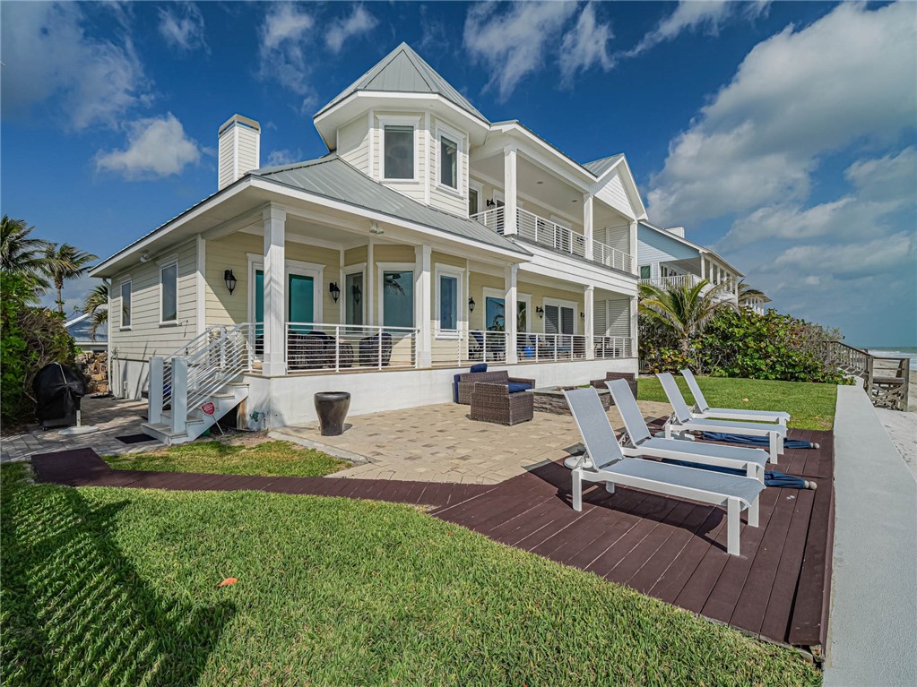2250 Sanderling Lane Vero Beach, FL 32963 - Photo 32 of 36 a view of a house with backyard sitting area and swimming pool