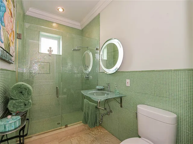 a bathroom with a toilet sink vanity and mirror