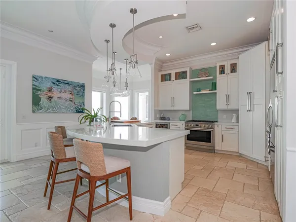 a kitchen with stainless steel appliances kitchen island granite countertop a sink and cabinets