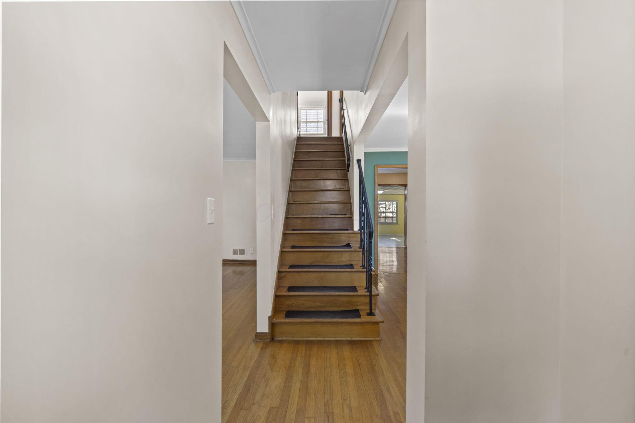 40 South Kellner Road Columbus, OH 43209 - Photo 9 of 57 Wood-finish flooring throughout, with a classic wooden staircase featuring a wrought iron railing