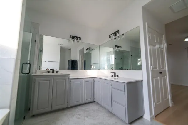 a bathroom with a double vanity sink and mirror