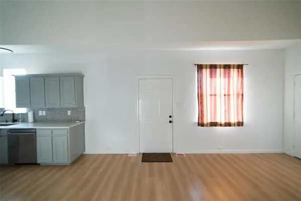 a view of a kitchen with wooden floor and electronic appliances