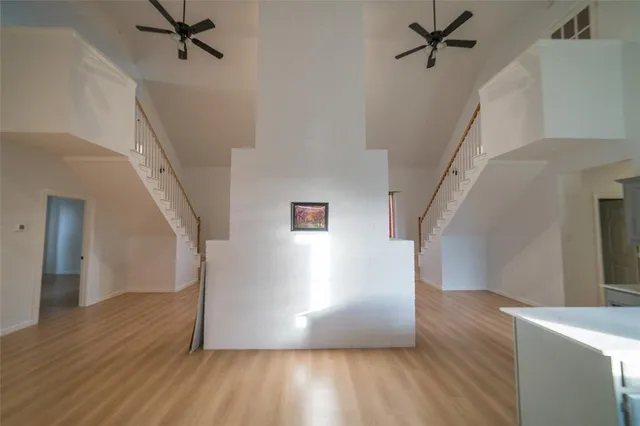 a view of a hallway view with wooden floor and staircase