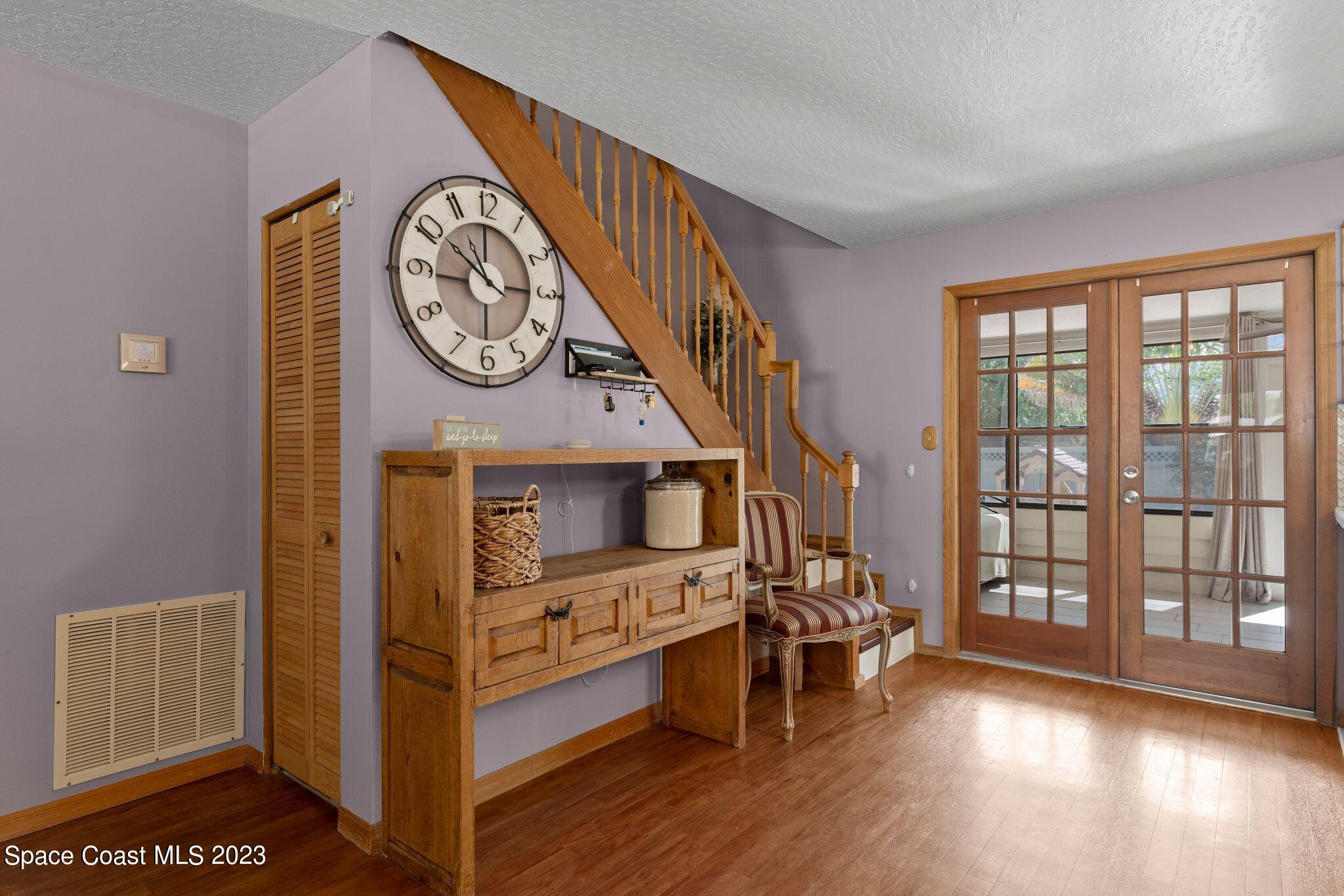 3704 Windsor Drive Cocoa, FL 32926 - Photo 18 of 48 a view of a hallway with wooden floor windows and a kitchen view