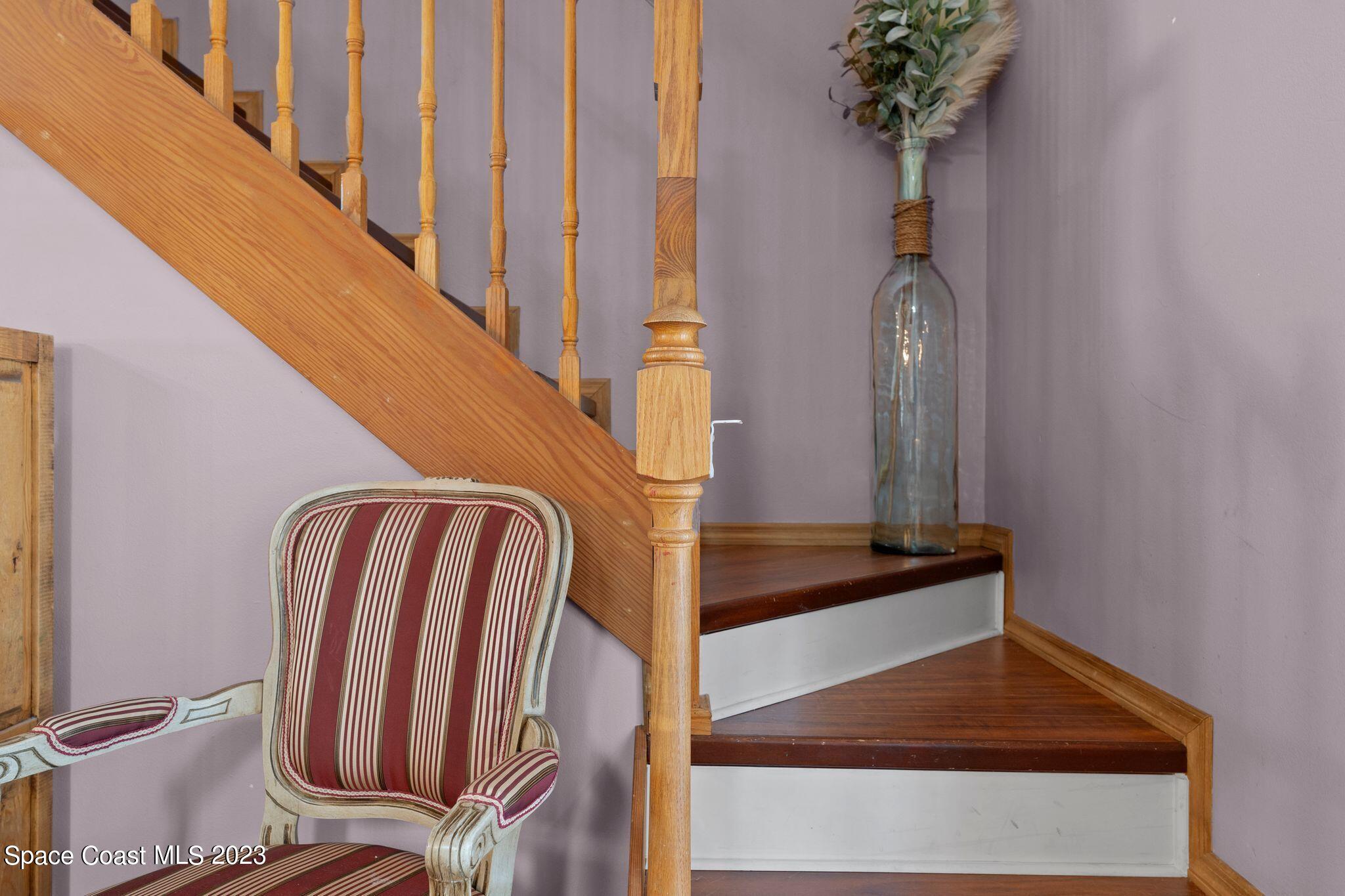 3704 Windsor Drive Cocoa, FL 32926 - Photo 19 of 48 a view of staircase with wooden floor and a potted plant