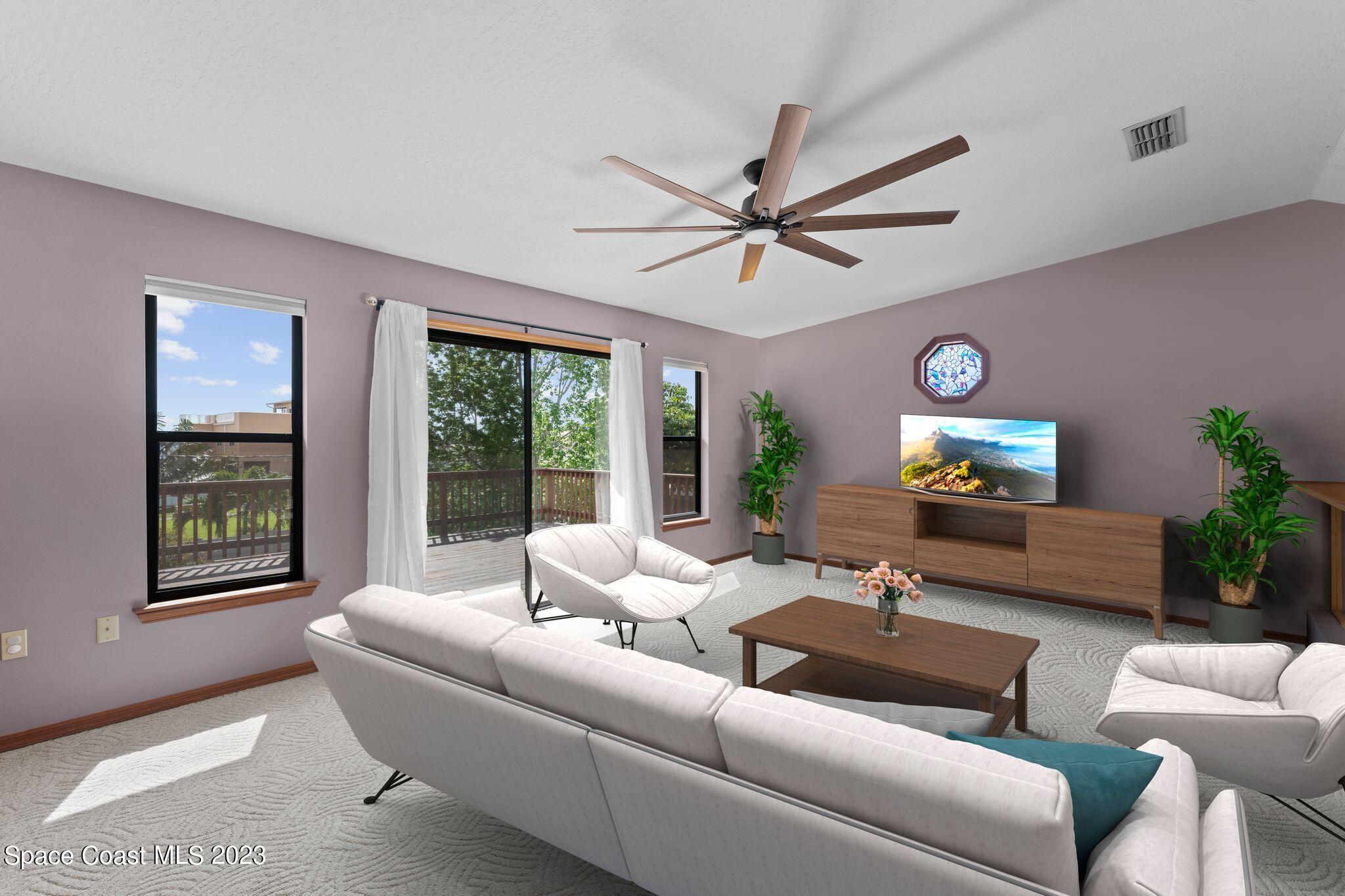 3704 Windsor Drive Cocoa, FL 32926 - Photo 20 of 48 a living room with furniture a large window and a flat screen tv