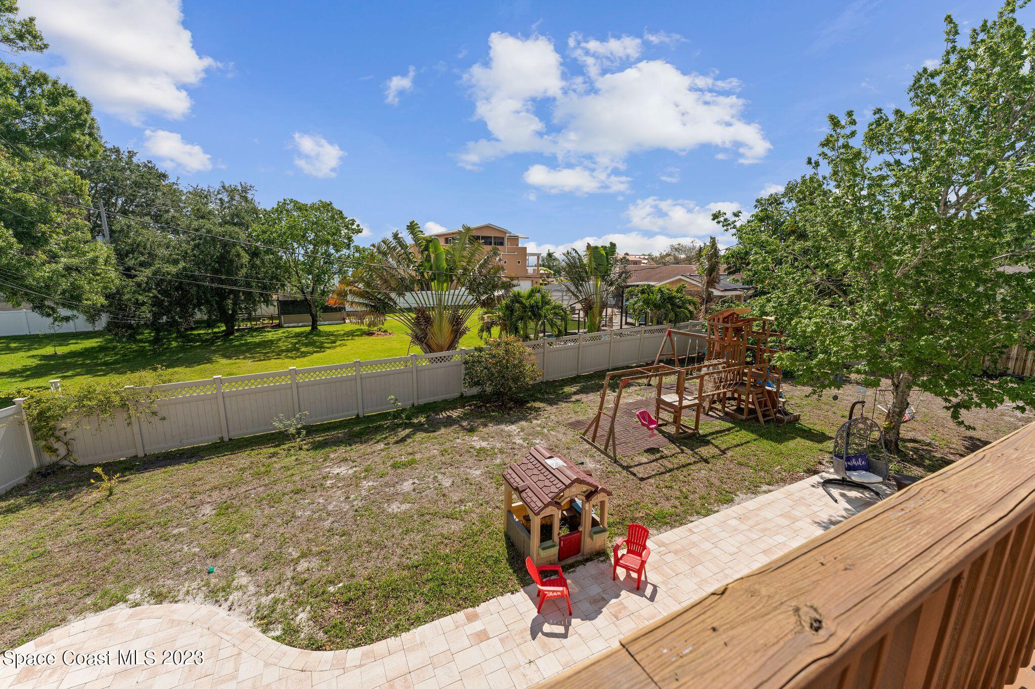 3704 Windsor Drive Cocoa, FL 32926 - Photo 24 of 48 a view of a backyard with plants and lake view