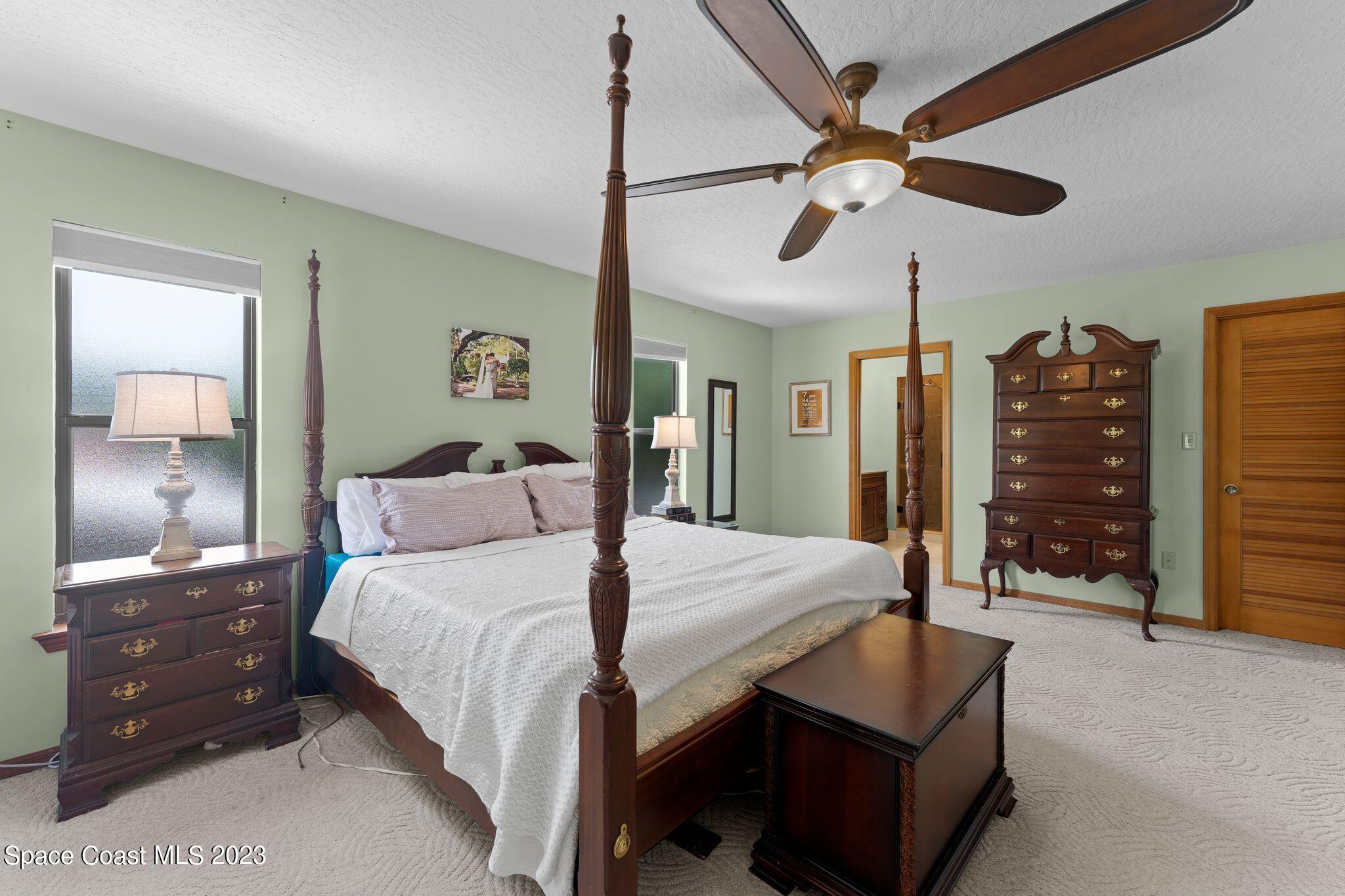 3704 Windsor Drive Cocoa, FL 32926 - Photo 25 of 48 a bedroom with a bed and a chandelier