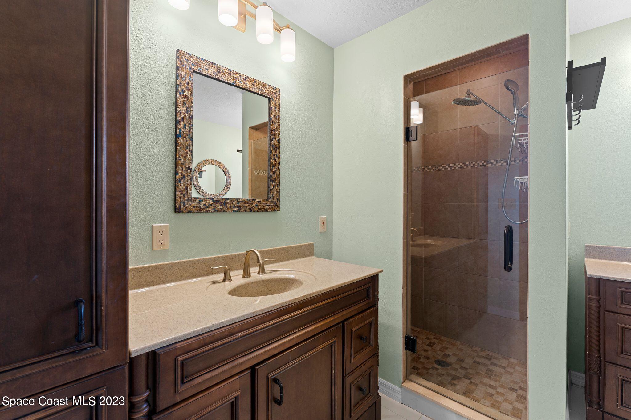 3704 Windsor Drive Cocoa, FL 32926 - Photo 29 of 48 a bathroom with a sink mirror and vanity