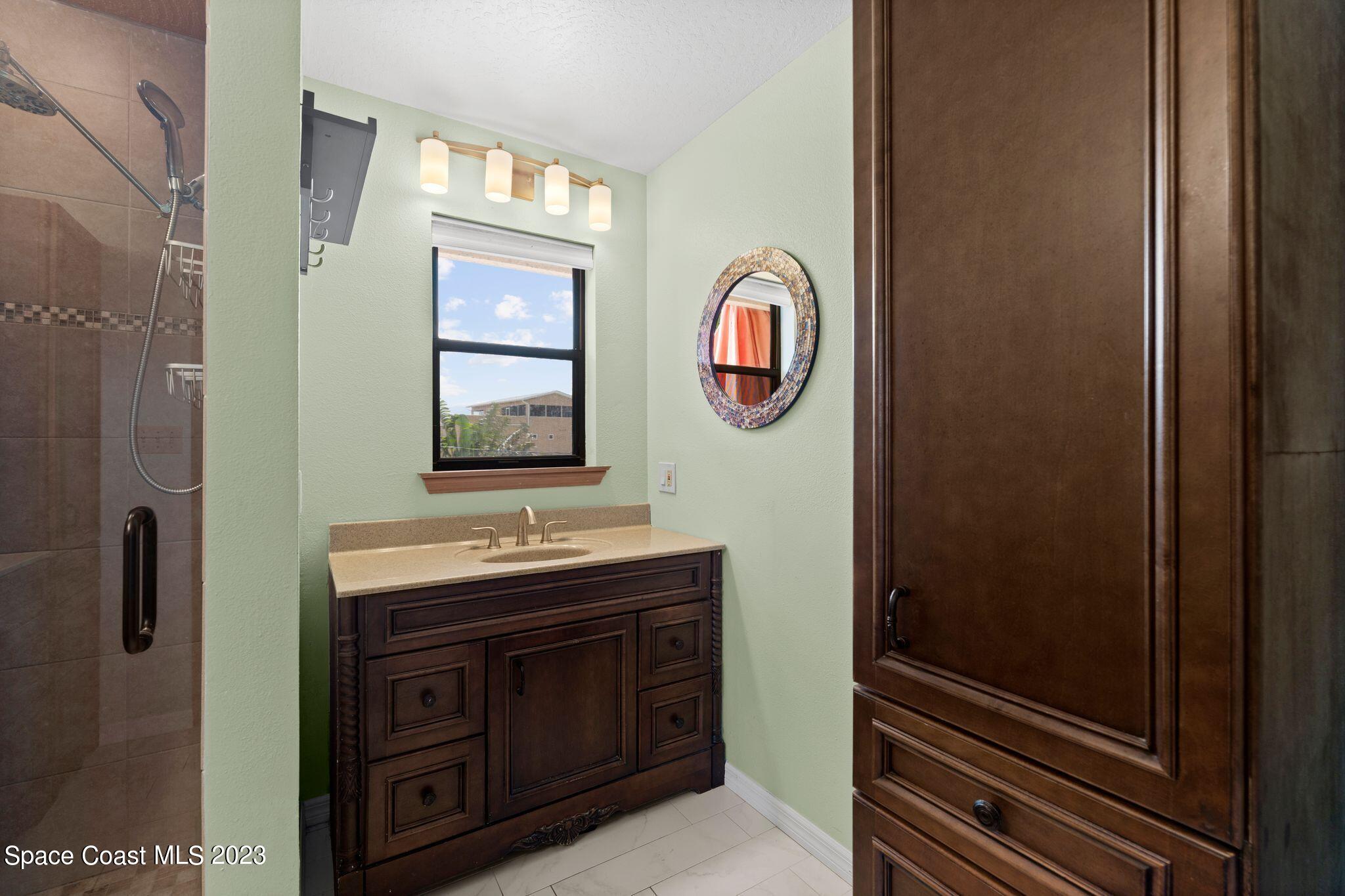 3704 Windsor Drive Cocoa, FL 32926 - Photo 30 of 48 a bathroom with a sink and a mirror