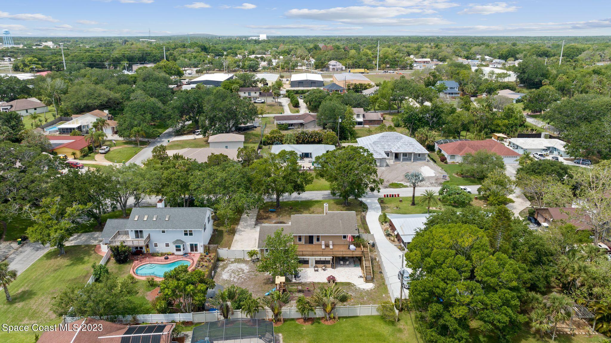 3704 Windsor Drive Cocoa, FL 32926 - Photo 3 of 48 an aerial view of residential houses with outdoor space and trees