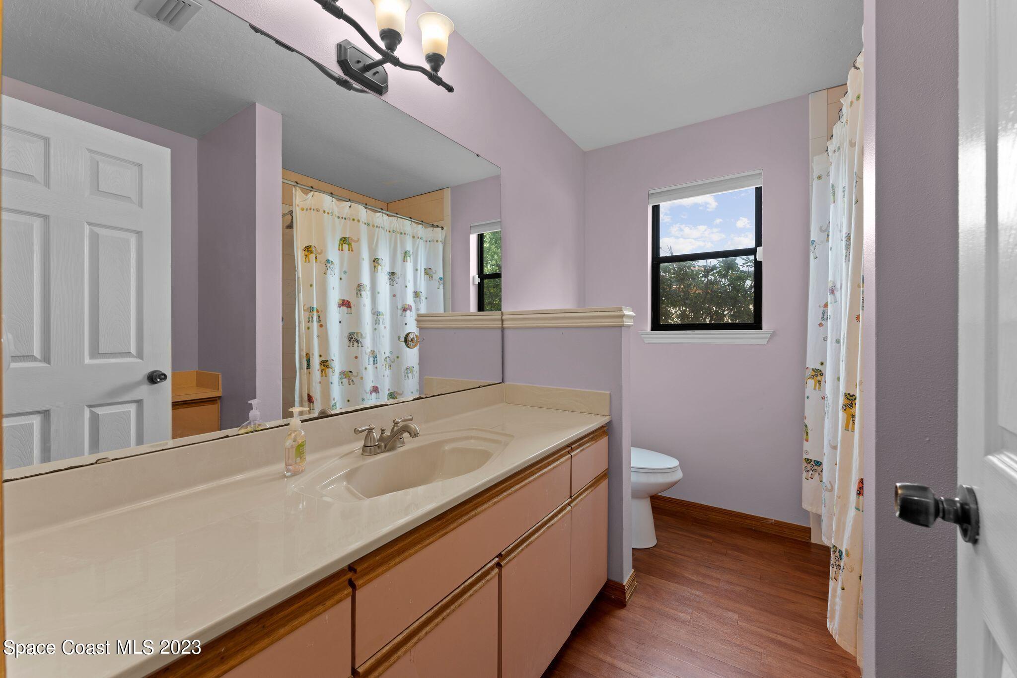 3704 Windsor Drive Cocoa, FL 32926 - Photo 33 of 48 a bathroom with a sink and a mirror