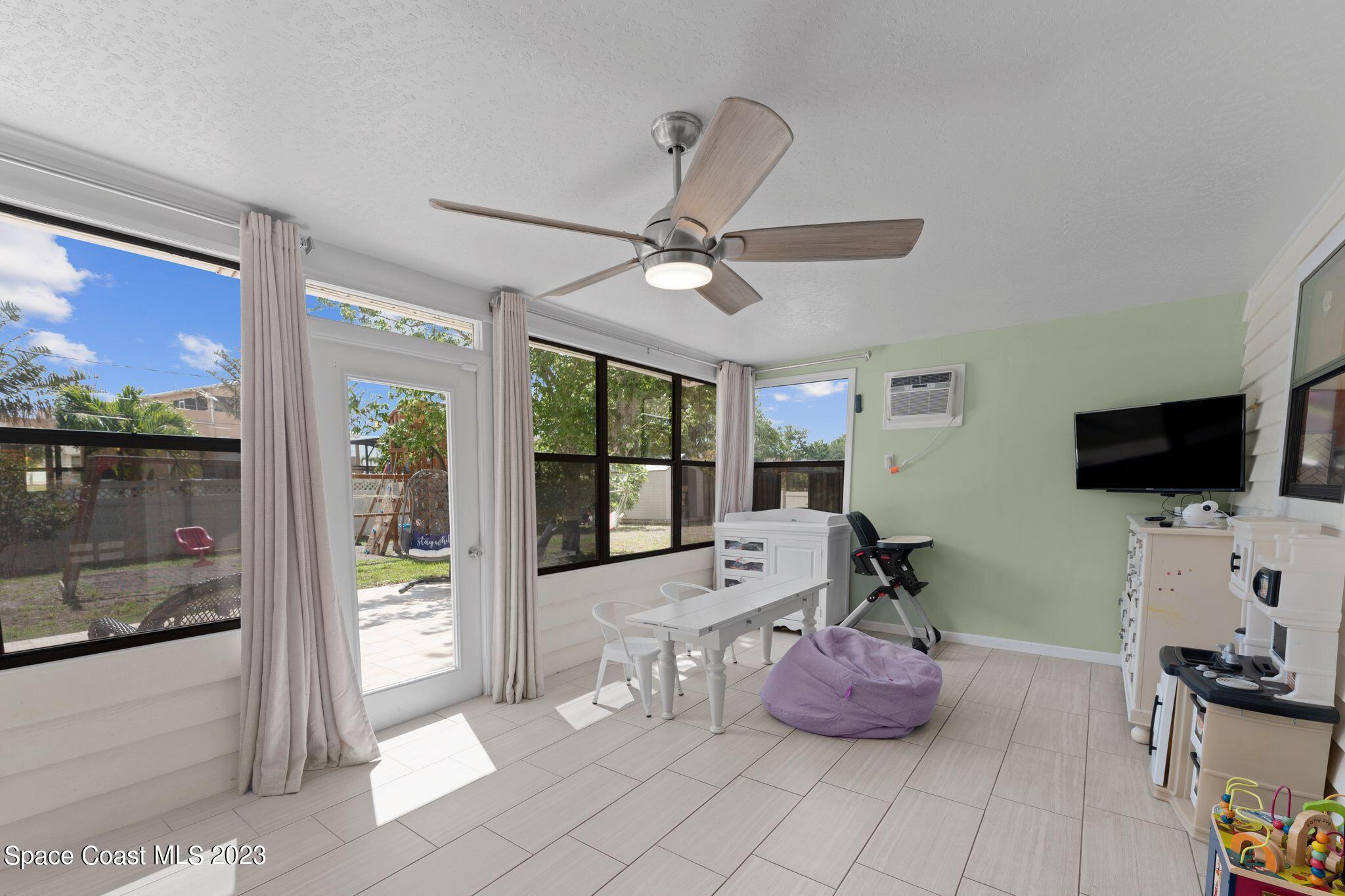 3704 Windsor Drive Cocoa, FL 32926 - Photo 34 of 48 a living room with furniture and a flat screen tv