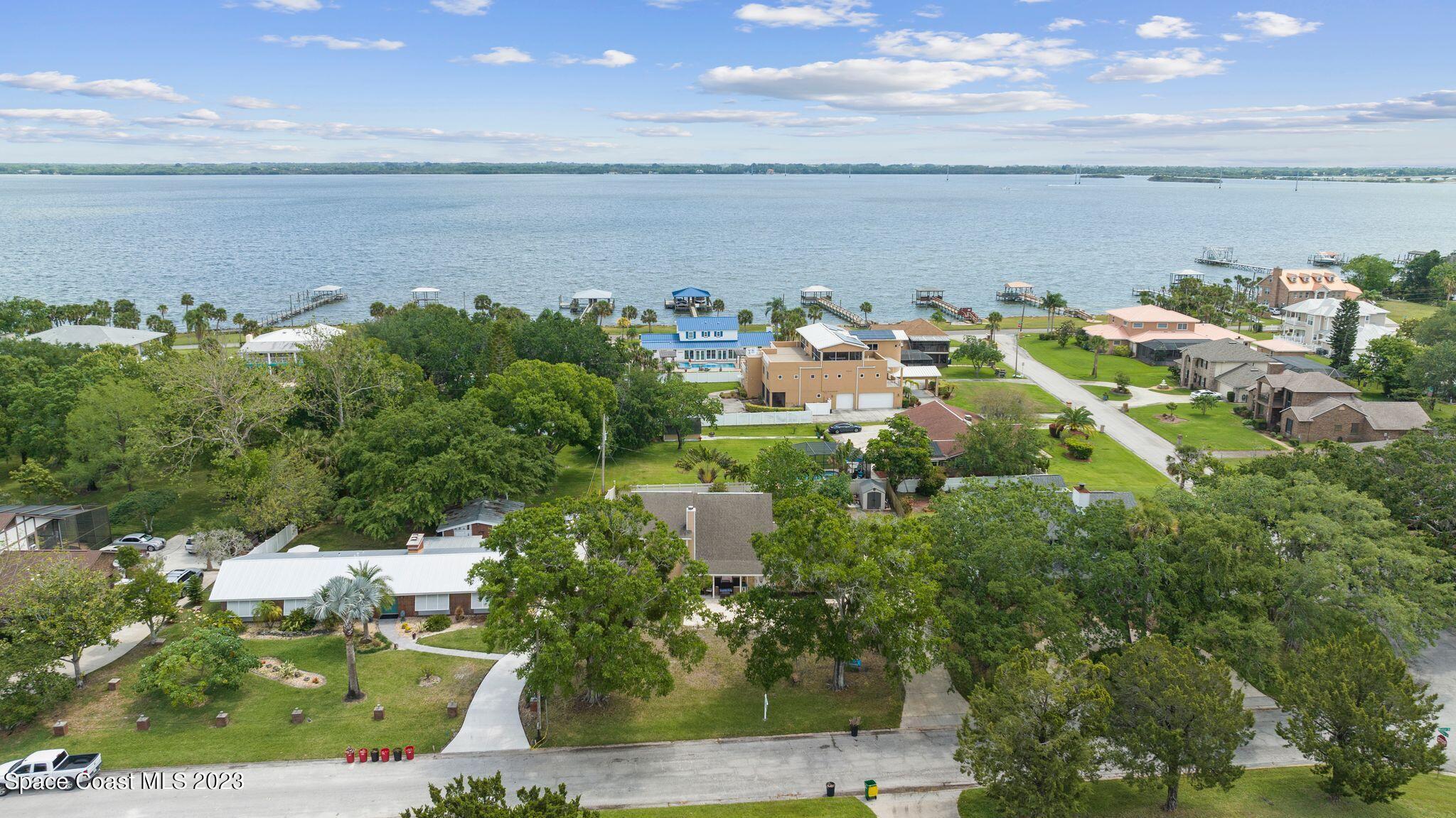 3704 Windsor Drive Cocoa, FL 32926 - Photo 42 of 48 a view of a lake with lawn chairs