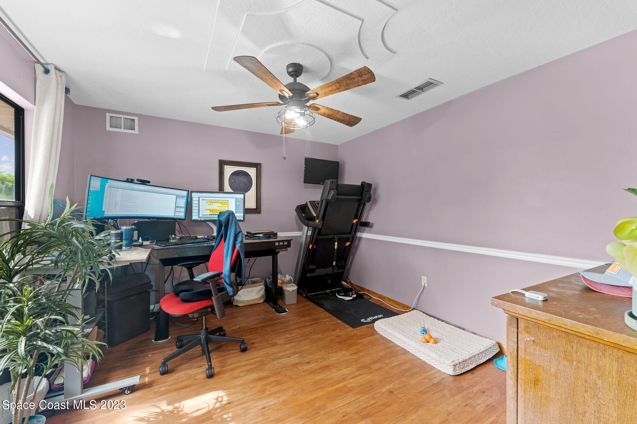 3704 Windsor Drive Cocoa, FL 32926 - Photo 47 of 48 a room with furniture a chandelier and a window