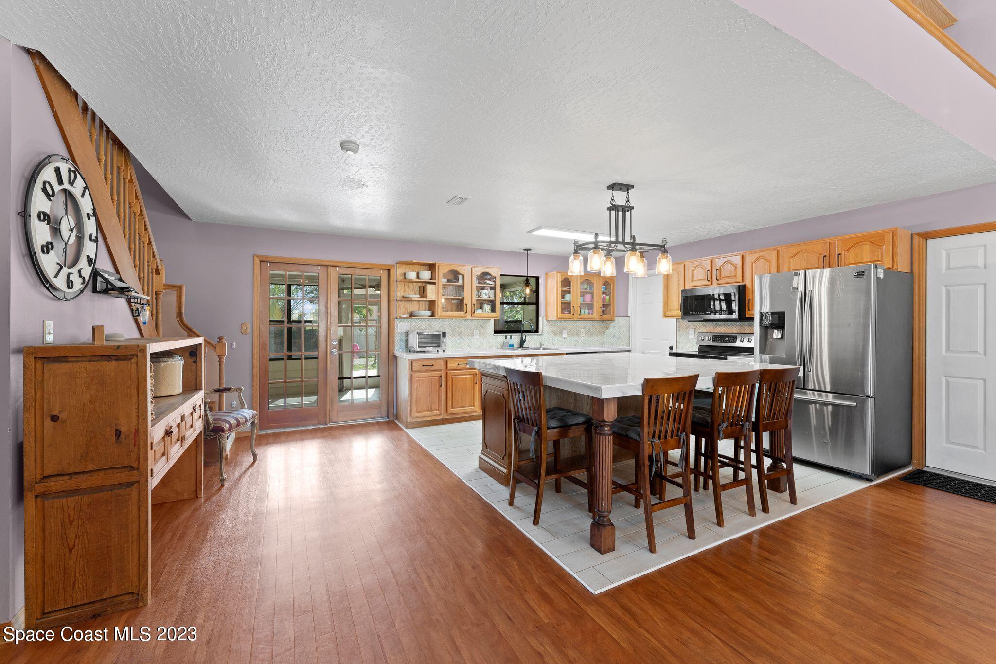 3704 Windsor Drive Cocoa, FL 32926 - Photo 6 of 48 a large kitchen with a table and chairs