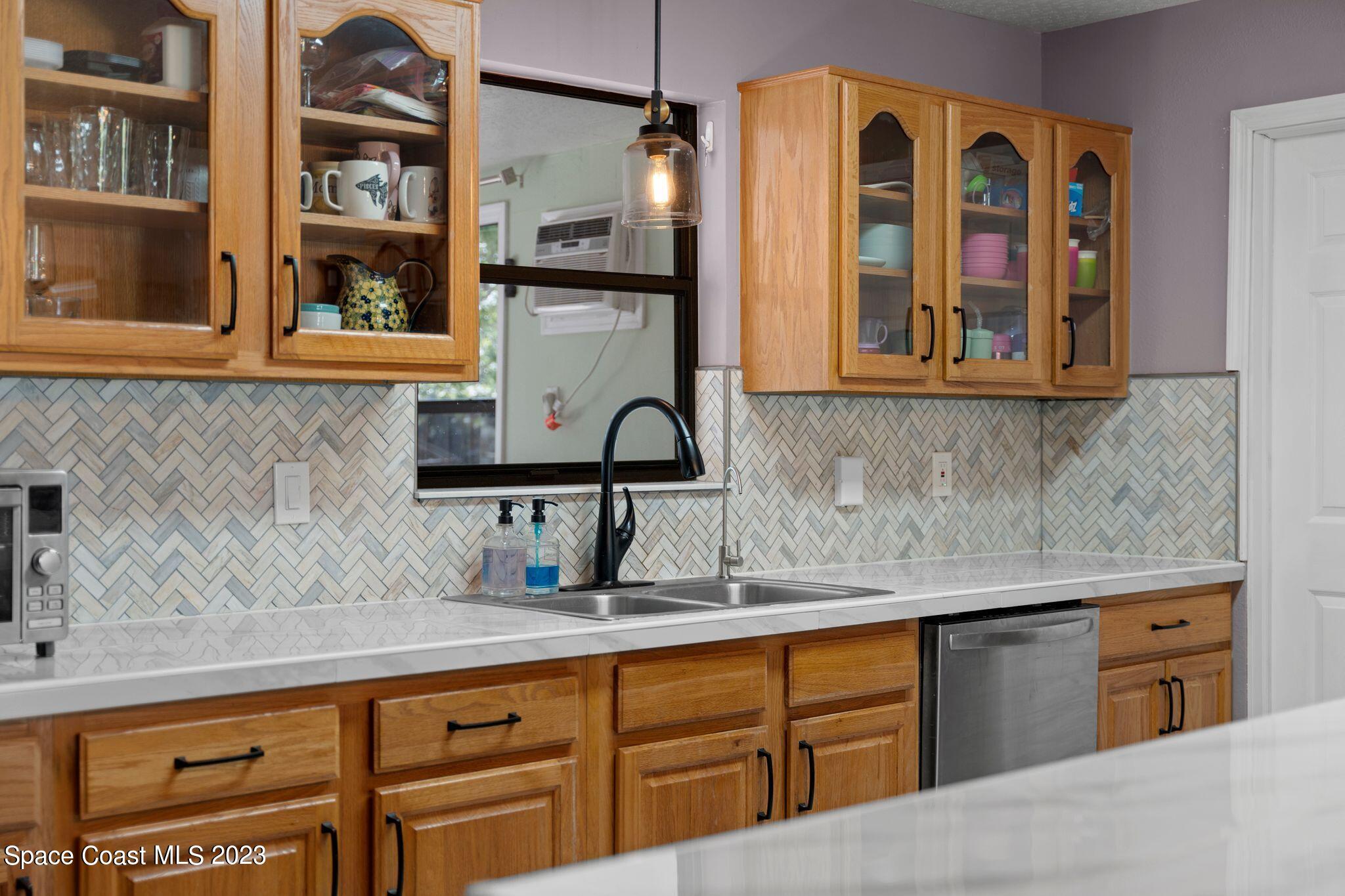 3704 Windsor Drive Cocoa, FL 32926 - Photo 10 of 48 a kitchen with stainless steel appliances granite countertop a sink and cabinets