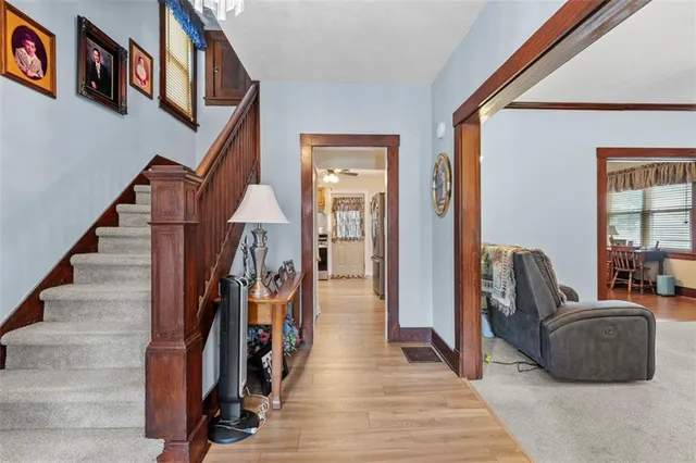 a hall way with furniture and a window