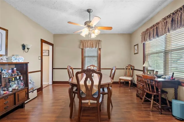 a view of a a dining room with furniture window and wooden floor