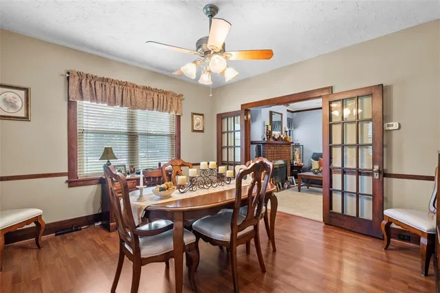 a dining room with furniture a window and wooden floor