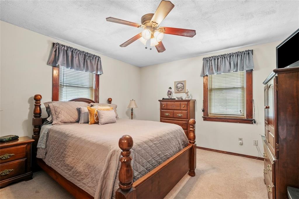 1170 Midland Beaver Road Industry, PA 15052 - Photo 20 of 34 a bedroom with a bed and a chandelier