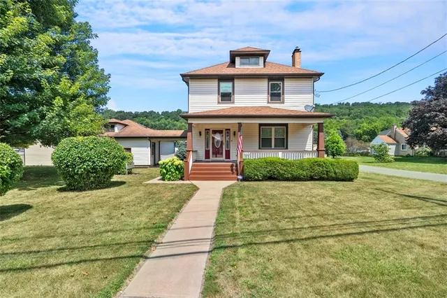 a front view of a house with a yard