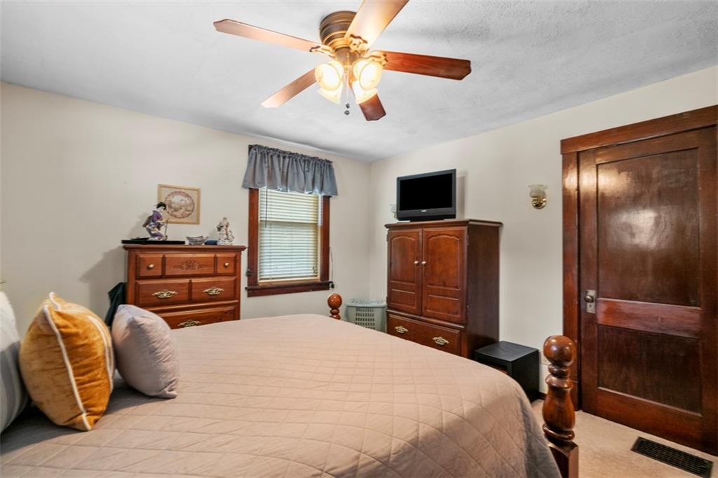 1170 Midland Beaver Road Industry, PA 15052 - Photo 21 of 34 a bedroom with a bed and dresser with chair