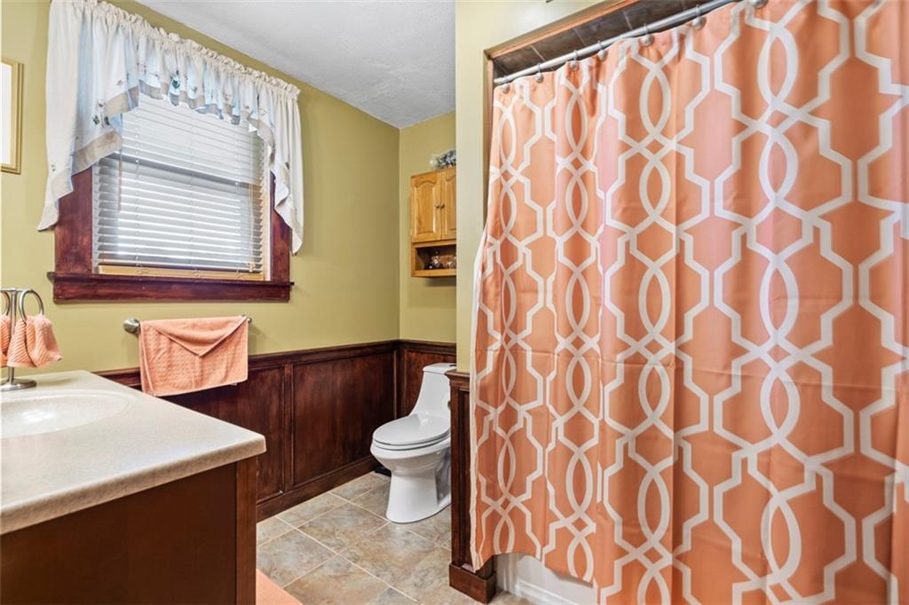 1170 Midland Beaver Road Industry, PA 15052 - Photo 22 of 34 a bathroom with a sink a toilet and a mirror