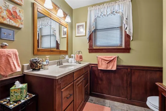 a bathroom with a sink vanity and a mirror