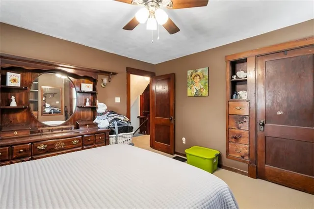 a bedroom with a bed and a large mirror with a bathroom