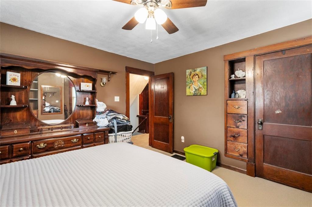 1170 Midland Beaver Road Industry, PA 15052 - Photo 25 of 34 a bedroom with a bed and a large mirror with a bathroom