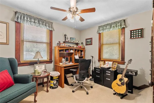 a view of a workspace with furniture and a window