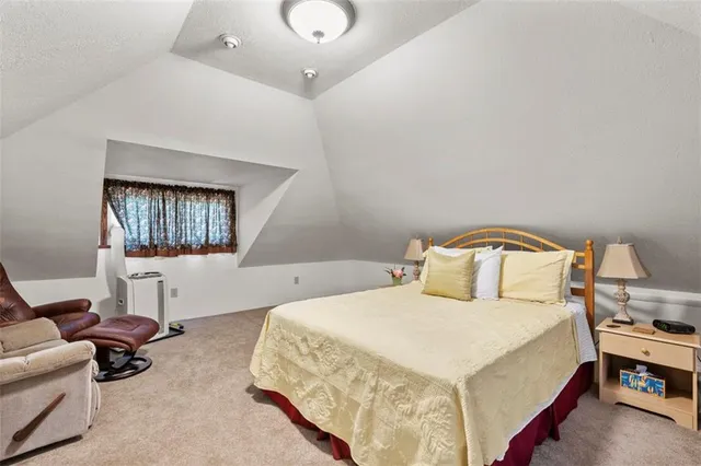 a bedroom with a bed and a mirror