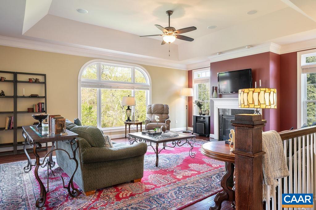 2706 Lockerbie Lane Keswick, VA 22947 - Photo 11 of 55 a living room with furniture fireplace and a large window