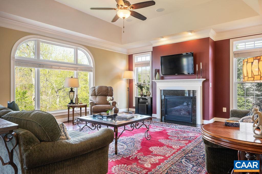 2706 Lockerbie Lane Keswick, VA 22947 - Photo 12 of 55 a living room with furniture a flat screen tv and a fireplace