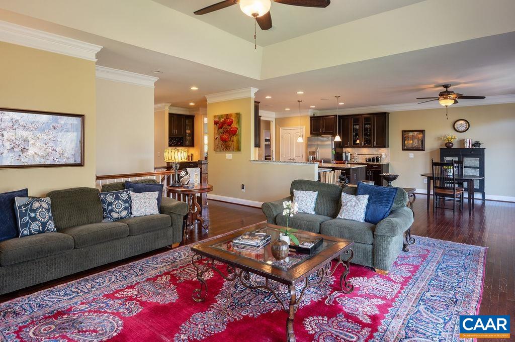 2706 Lockerbie Lane Keswick, VA 22947 - Photo 54 of 55 a living room with furniture a rug and a chandelier