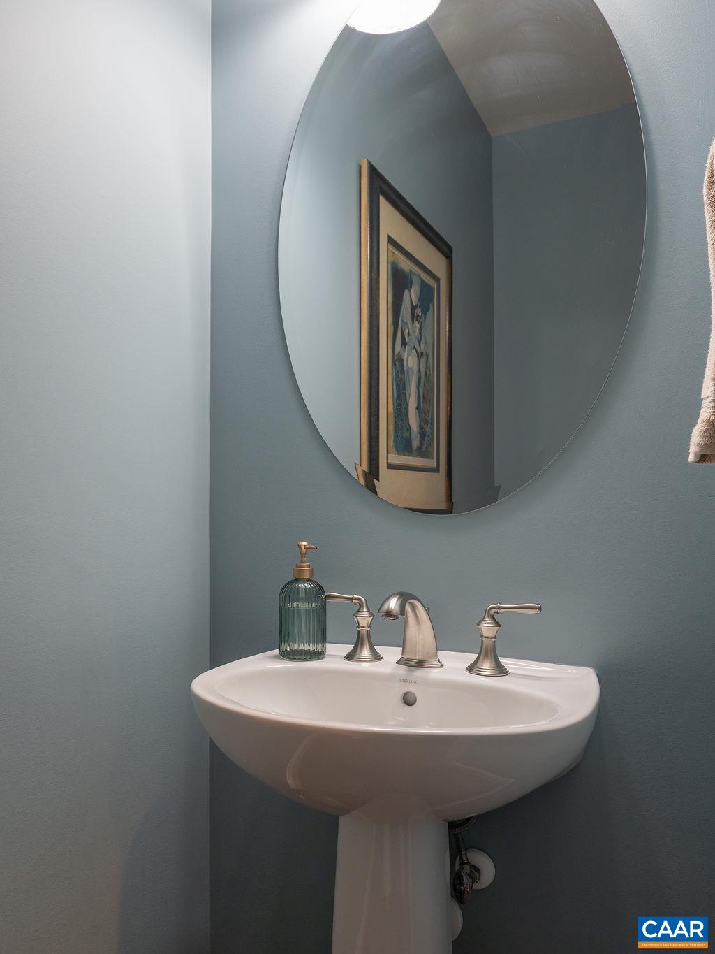 2706 Lockerbie Lane Keswick, VA 22947 - Photo 30 of 55 a bathroom with a sink and mirror