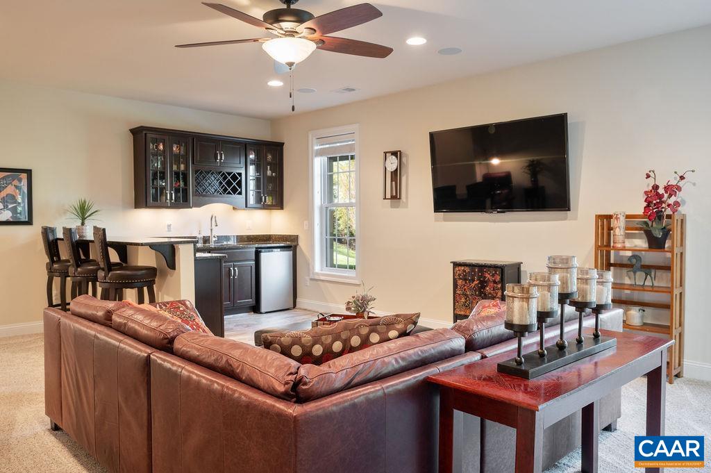 2706 Lockerbie Lane Keswick, VA 22947 - Photo 32 of 55 a living room with fireplace furniture and a flat screen tv